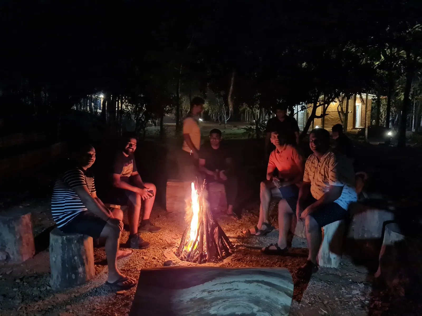 The campfire near the tents after dark