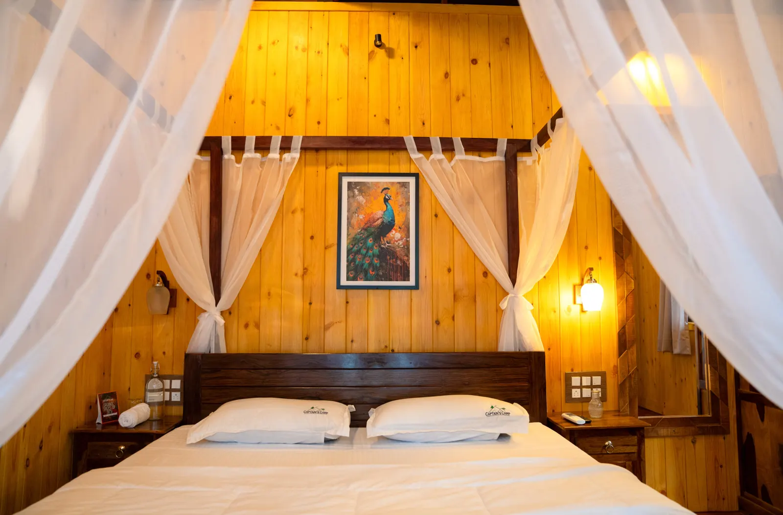 The Machan's four-poster bed under a timber ceiling