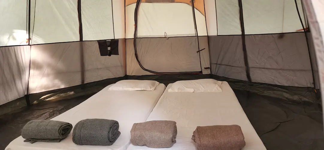 Inside the tent — a real bed under canvas